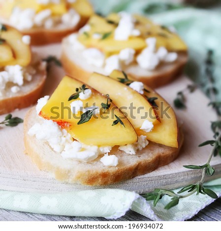 Toasted wheat bread with ripe peaches, crumbled feta or cottage cheese, honey and thyme for snack or summer picnic