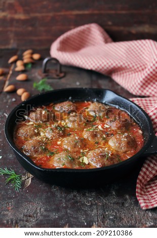 Meatballs with tomato sauce in a pan, selective focus