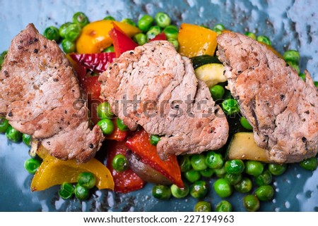Barbecue Grilled Beef Steak Meat with Vegetables, roasted bell pepper, zucchini or courgette, green peas