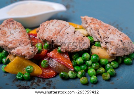 Beef steak with roasted pepper, eggplant, onion with cream sauce, selective focus
