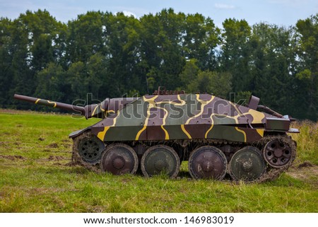 German self-propelled artillery installation of times of World War II, standing in a field near the forest