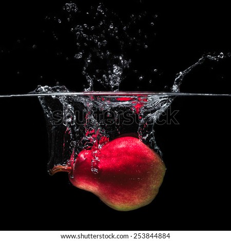 Pear in water on a black background