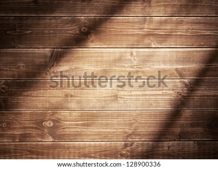 Wooden wall background in a evening light. With shadows from a window frame.