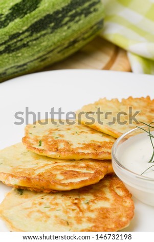 Fried zucchini pancakes with fresh sour cream