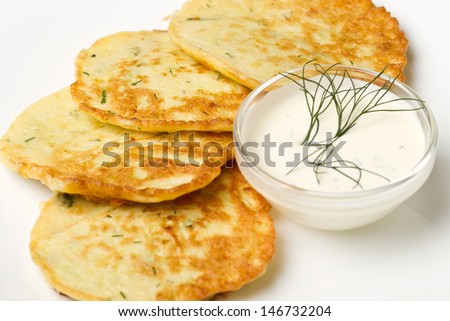 Fried zucchini pancakes with fresh sour cream