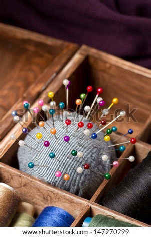Sewing pins and pin cushion in wooden box