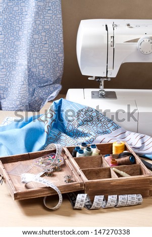 Sewing mashine,fabric and material for sewing in wooden box