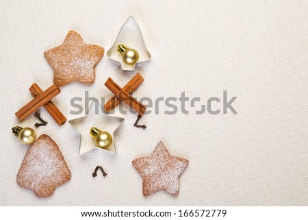 Christmas gingerbread cookies, cinnamon sticks, cookie cutters and christmas ball on white
