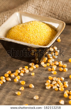 Corn grits in bowl and corn seeds