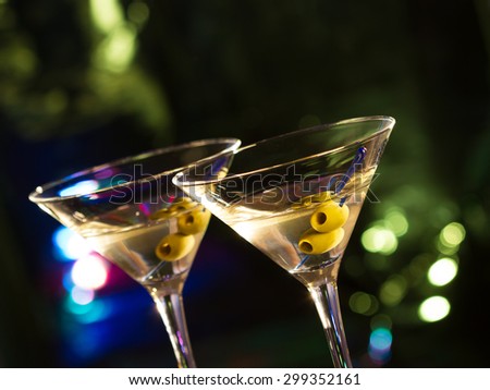 Two glasses with martini , focus on a olives