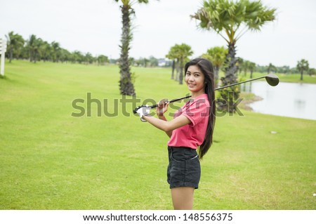Golf girl with driver at green