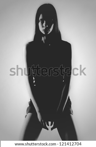 Silhouette of a girl sitting on a white background.