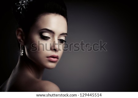 Young woman with beautiful make-up, look down.