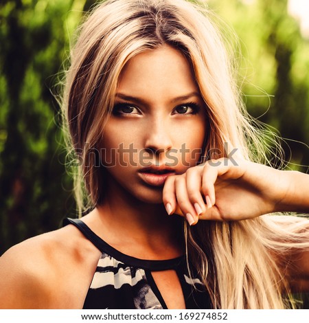 Beautiful girl holding a hand to his face, close-up portrait