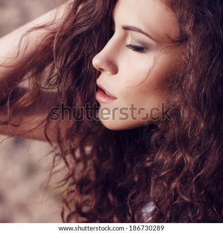 Portrait of the beautiful girl close-up, the wind fluttering hair.
