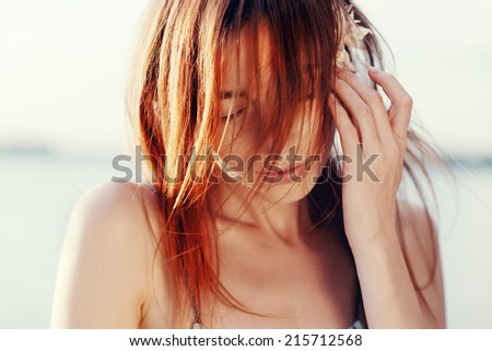 Portrait of the beautiful girl close-up, the wind fluttering hair, with eyes closed