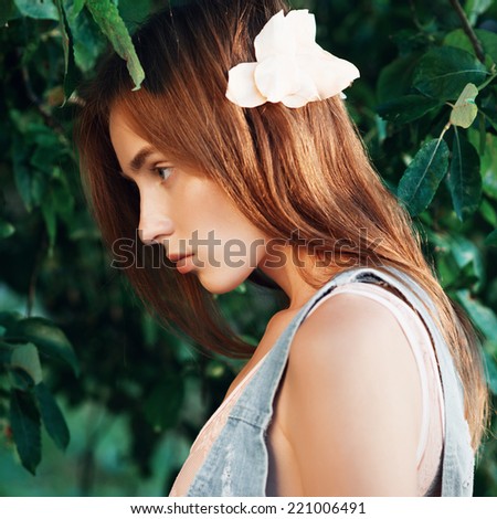 Portrait of beautiful girl in fashionable clothes, standing in profile, lifestyle