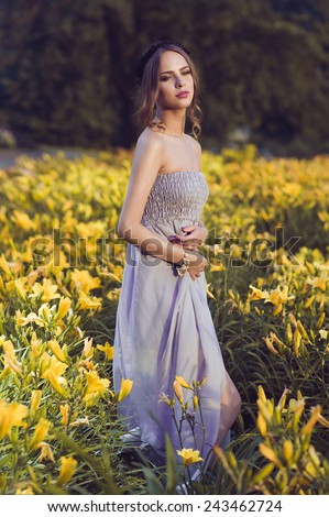 Portrait of a beautiful young girl in a summer field with yellow flowers, the concept of health and beauty