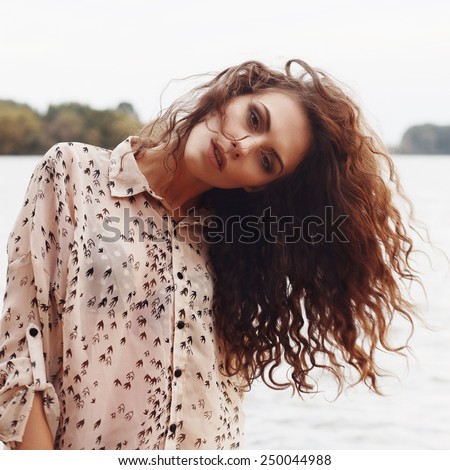Portrait of the beautiful young girl close-up, the wind fluttering hair