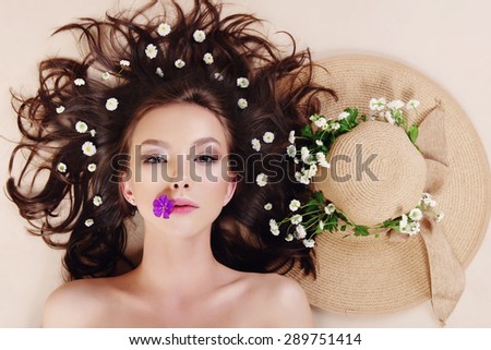 Portrait of a beautiful girl with flowers in her hair, spa concept
