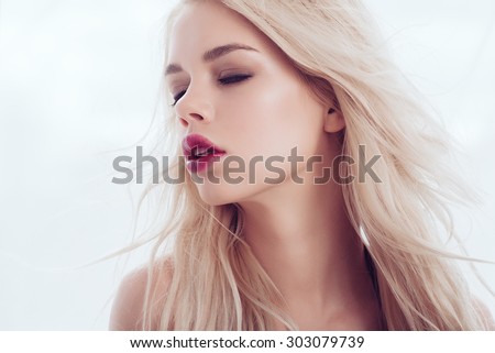 Portrait of a beautiful young blonde girl with long hair, the concept of beauty and health