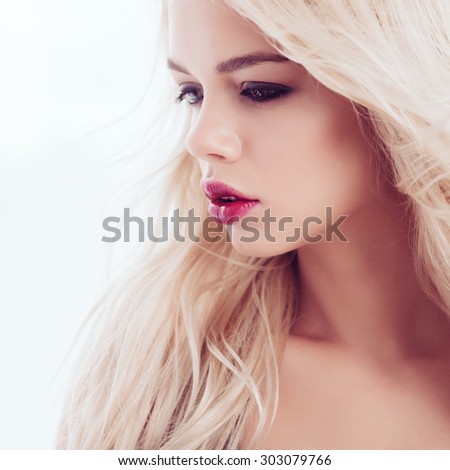 Portrait of a beautiful blonde girl with long hair, the concept of beauty and health