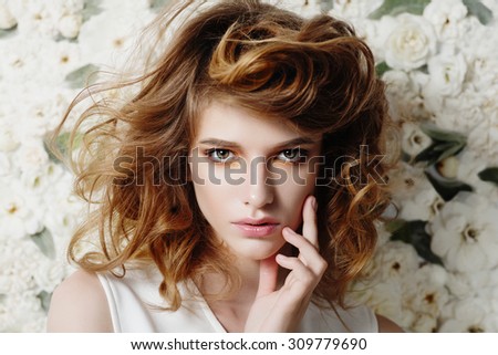 Portrait of attractive young girl on a background of white flowers, the concept of beauty and health