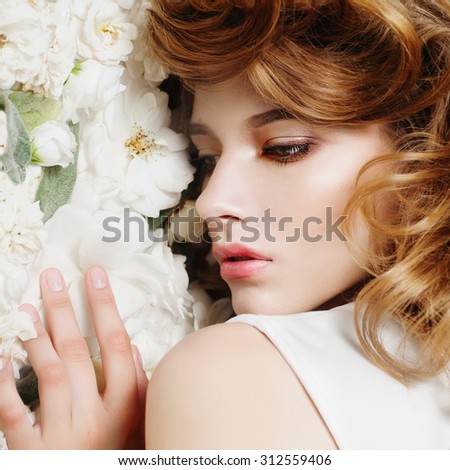 Beautiful girl on a background of white flowers, the concept of beauty and health