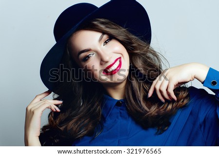 Portrait of a beautiful and positive young girl in a blue hat with expressive eyes