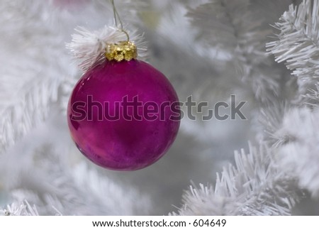 magenta christmas ornament on white tree with space for writing
