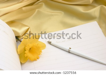 open guest book (text area) with yellow daffodils on yellow satin