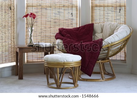 papasan chair with stool, coffee table and flowers