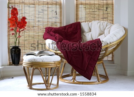 Papasan chair w cushion stool and vase with Gladiolus flowers