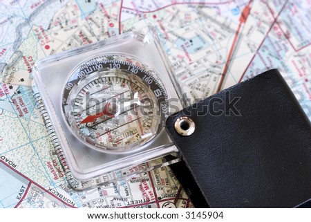 Compass with case on a road map