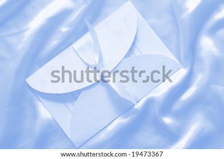Wedding invitation on blue silk