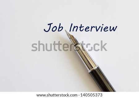 Pen is placed on the paper bellow job interview text