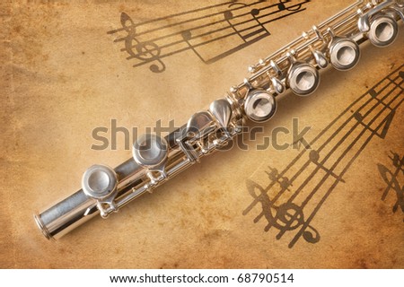 Silver flute on an ancient musical background