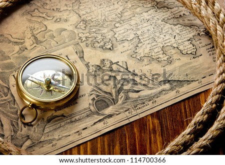 old compass and rope on vintage map 1733
