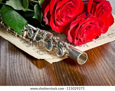 Silver flute, notes and roses. Musical background.