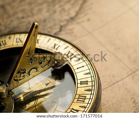Old compass on vintage map. Adventure stories background