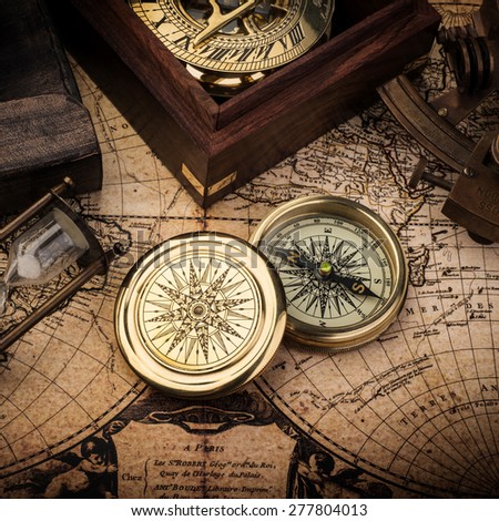 Old compass, astrolabe on vintage map. Retro stale.