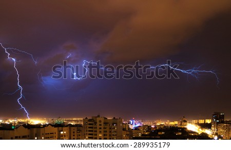 Photo of beautiful powerful lightning over city, zipper and thunderstorm, abstract background.