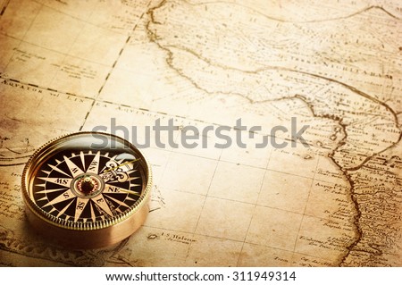 Old compass and vintage map. Retro stale.