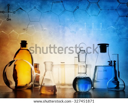 Test glass flask with solution in research laboratory. Science and medical background. Focus in the foreground.