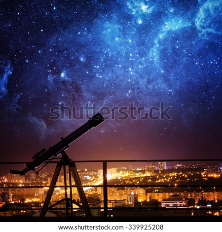 Silhouette of Telescope on background stars and night city. Elements of this image furnished by NASA.