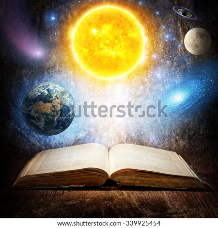 Opened magic book with sun, earth, moon, saturn, stars and galaxy. Concept on the topic of astronomy or fantasy.  Elements of this image furnished by NASA.