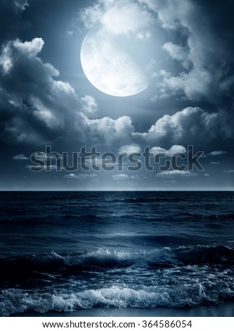 Night sky with full moon and reflection in sea. Elements of this image furnished by NASA