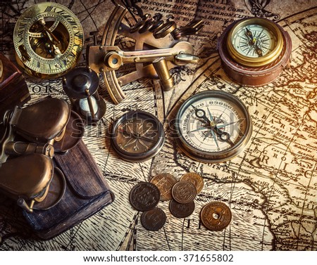 Old compass, astrolabe on vintage map. Retro style.