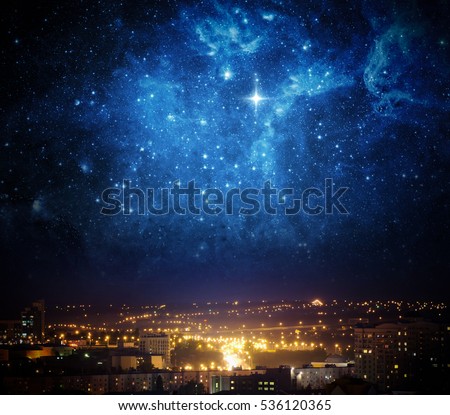 City landscape at nigh with sky filled with stars. Elements of this image furnished by NASA