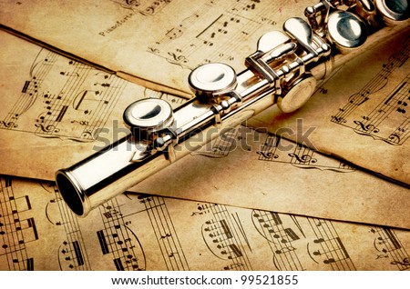 Silver flute on an ancient musical background (author of notes  Franz Peter Schubert 1797-1828, publisher Julius Heinrich Zimmermann 1851-1923)